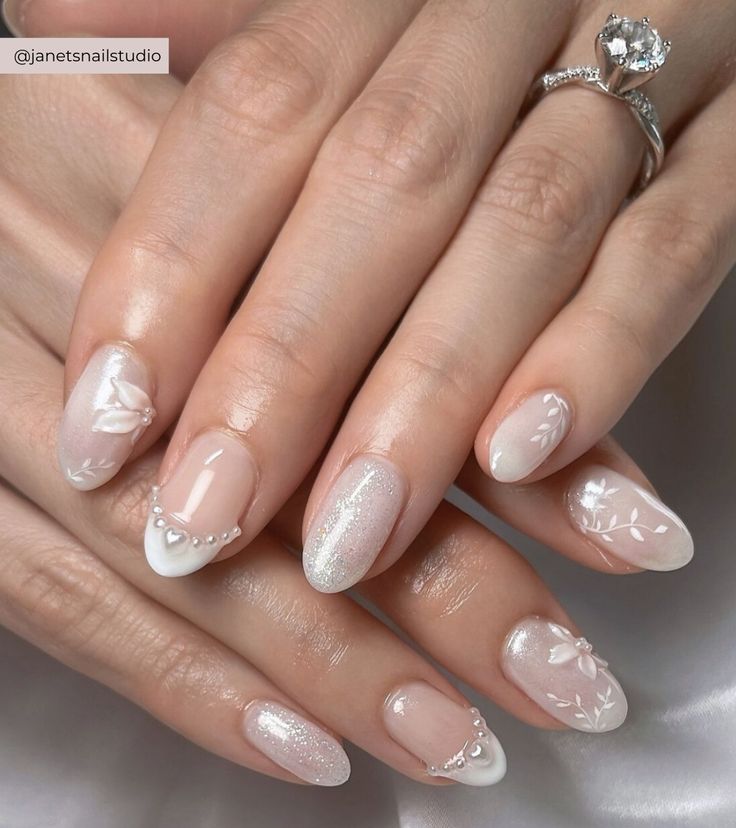 Sophisticated Nail Design: Soft White with Floral Patterns and Shimmering Accents.