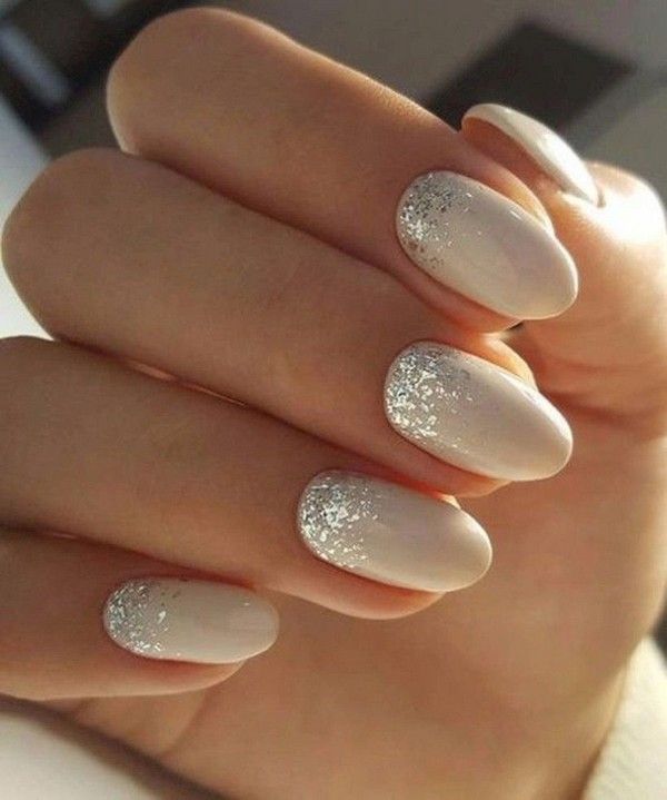 Elegant Beige Nail Design with Subtle Shimmer and Silver Glitter Tips for Versatile Chicness.