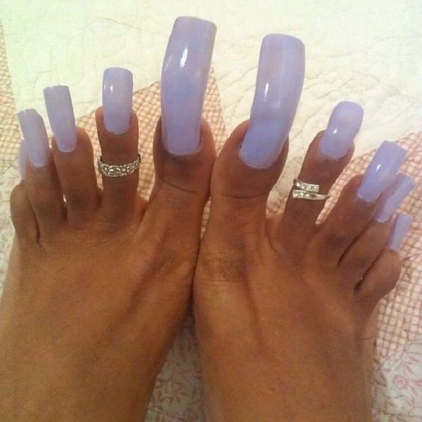 Elegant Long Glossy Lavender Nail Design with Delicate Silver Accents.