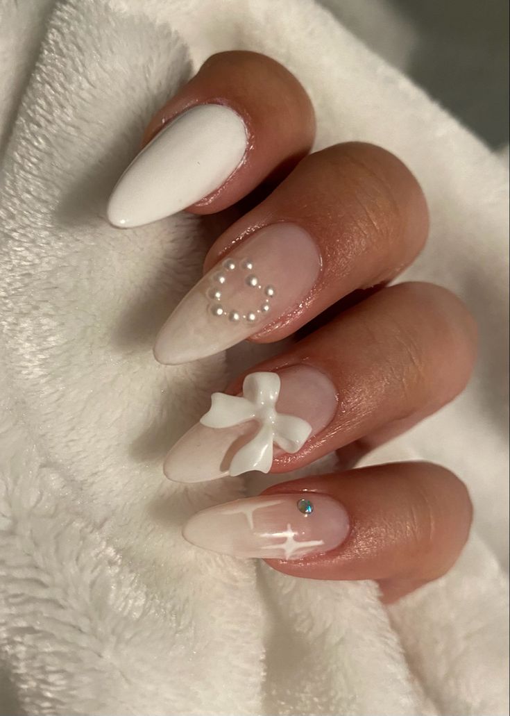 Chic Nail Design: Glossy White and Nude with Pearl Accents and Glamorous Gem Highlights.