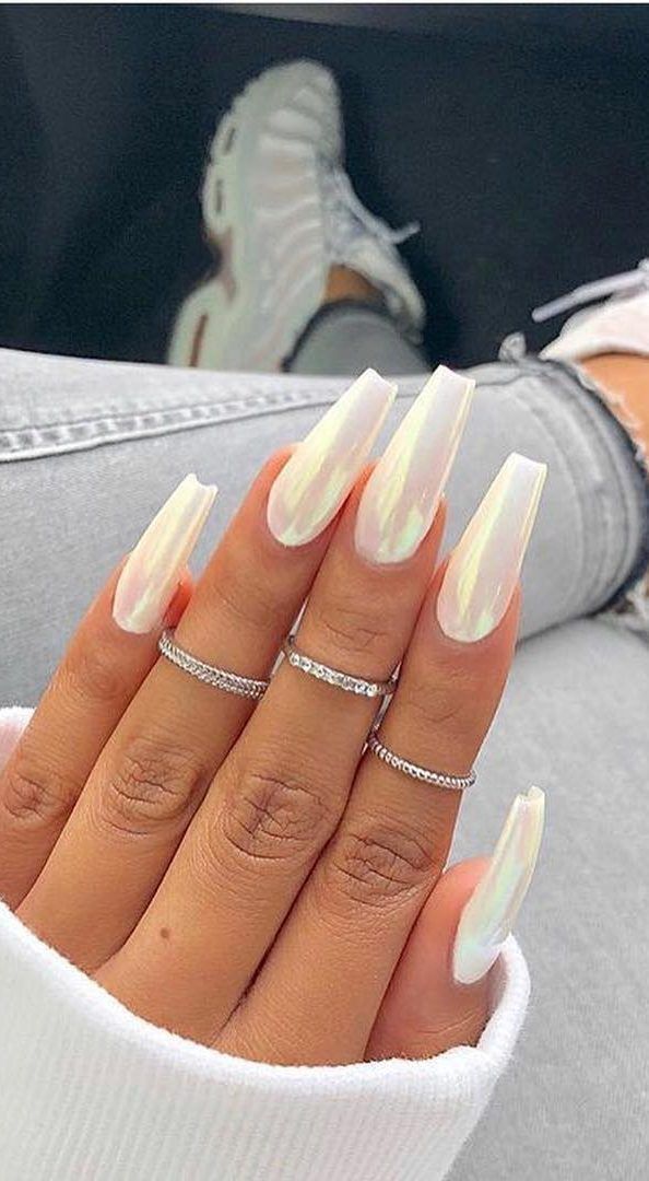 Elegant Iridescent Long Nails Paired with Sophisticated Silver Rings