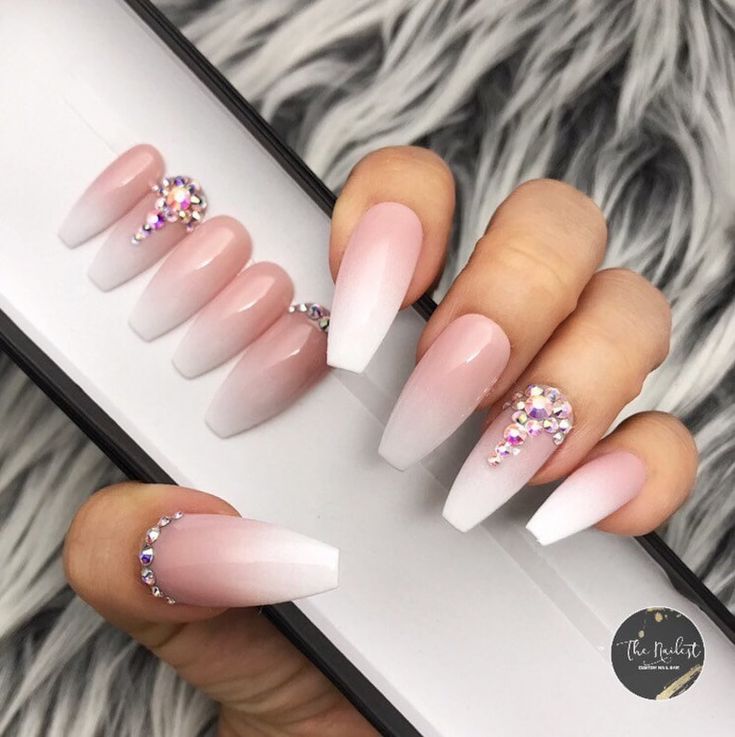 Sophisticated Ombre Nails with Pink to White Gradient and Sparkling Rhinestones for Glamorous Elegance.