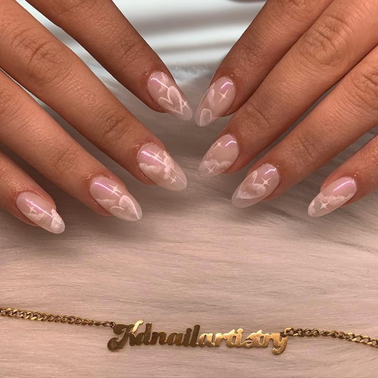 Charming Nude Nails with Delicate Heart Designs and Subtle Shimmer.