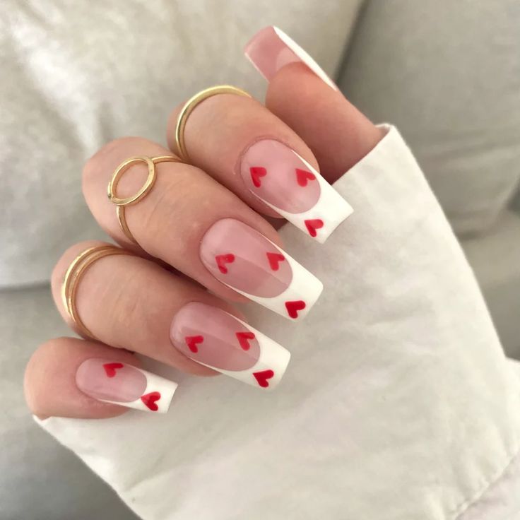 Chic Modern French Tip Nail Design with Vibrant Red Heart Accents.