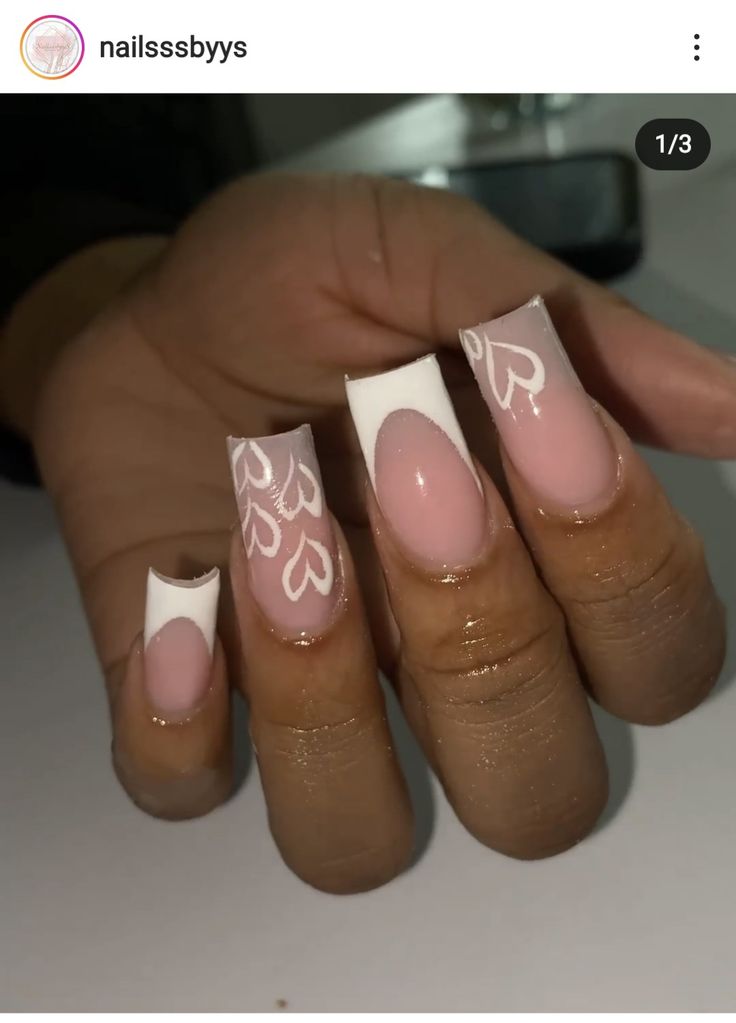 Romantic Almond-Shaped Nail Design with Soft Pink Base and Heart Patterns