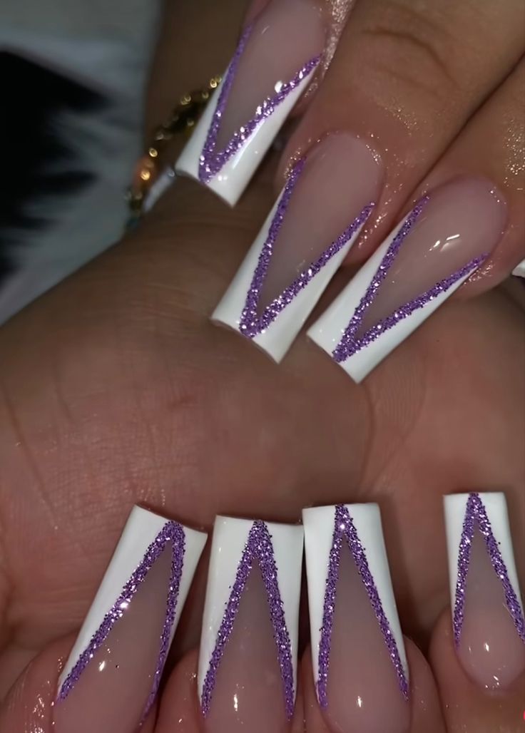 Fashionable Long Squared Tip Nail Design with Bold White Base and Shimmering Purple Chevron Accents.