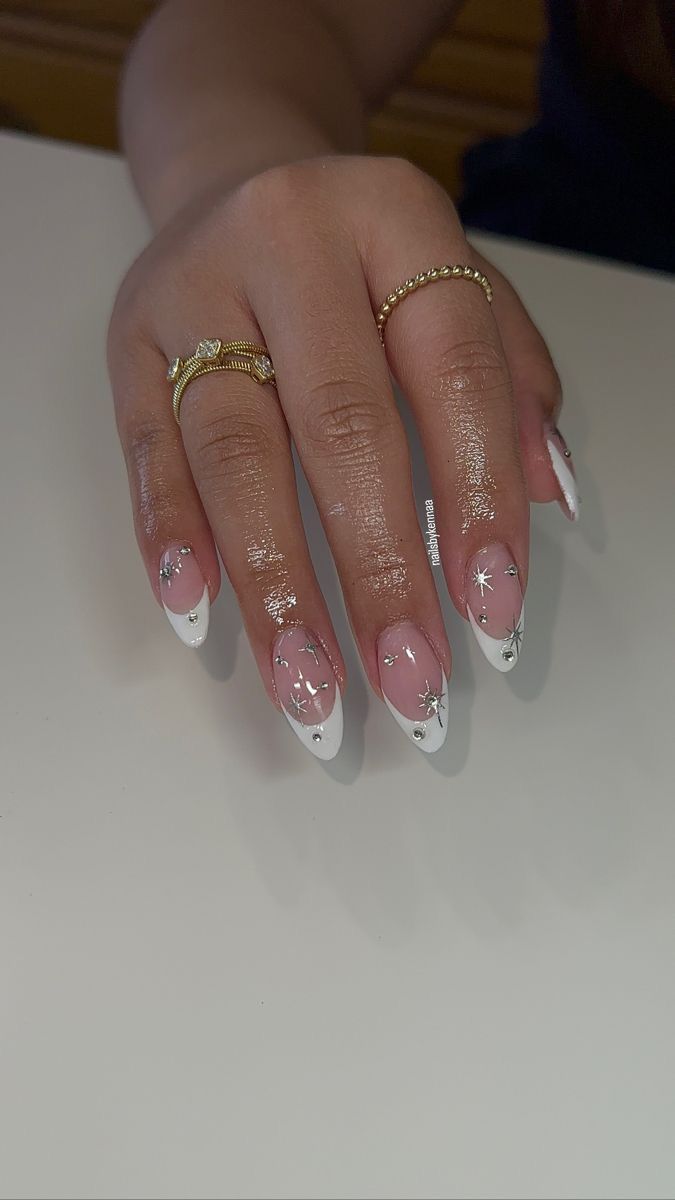 Chic Almond-Shaped Nail Design in Soft Pink and White with Silver Accents.