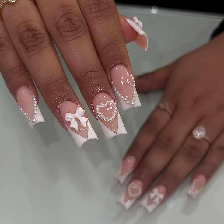 Romantic Soft Pink and White Nail Art with Elegant Embellishments.