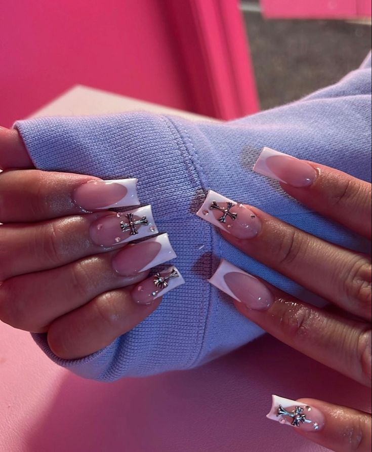 Stylish Soft Pink and Classic French Tip Nail Design with Glamorous Embellishments.