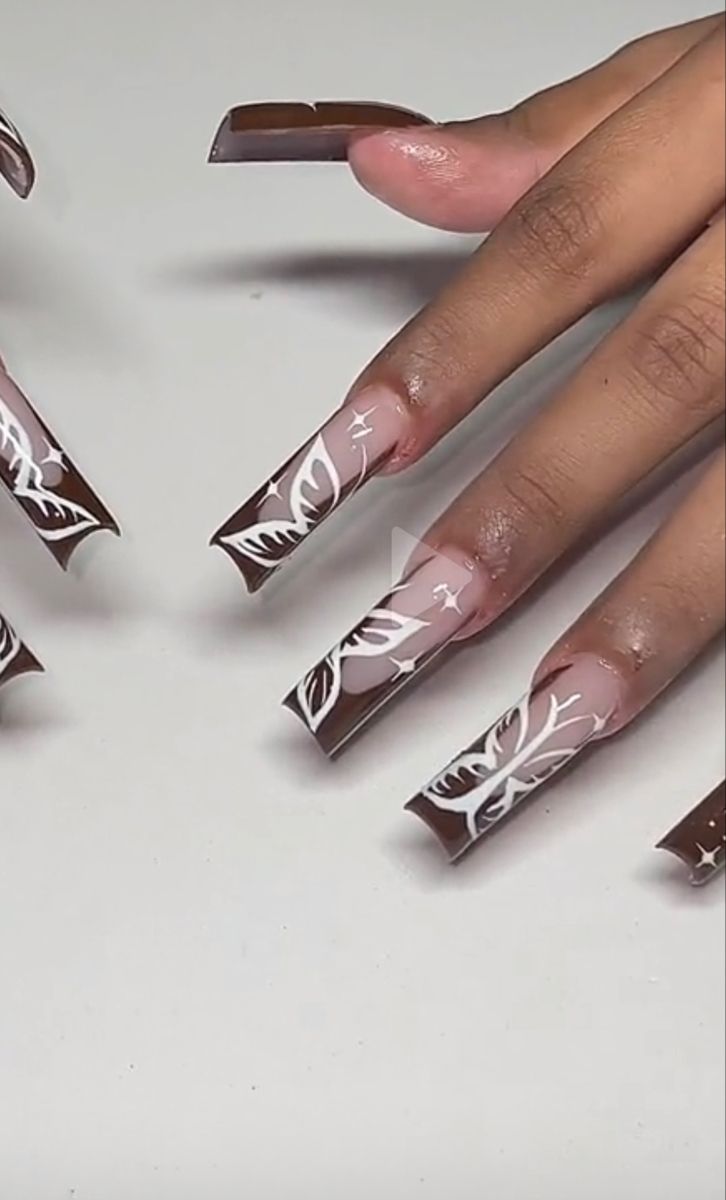 Chic Elegant Nail Design: Rich Brown Base with Intricate White Floral Patterns