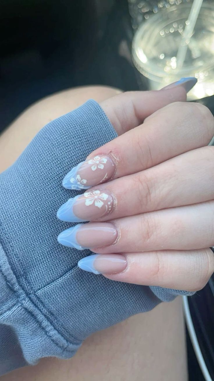 Spring-Inspired Elegant Nail Design with Soft Blue French Tips and Floral Accents.