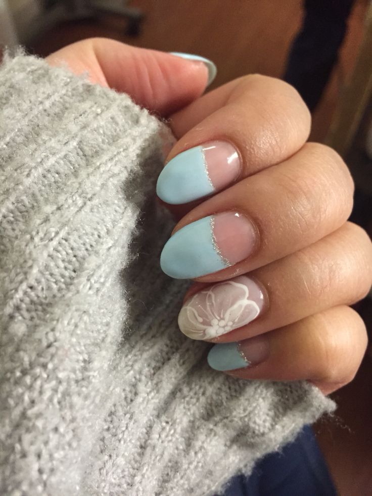 Charming Pastel Blue Nail Design with Floral Motif and Sparkly Silver Accents.