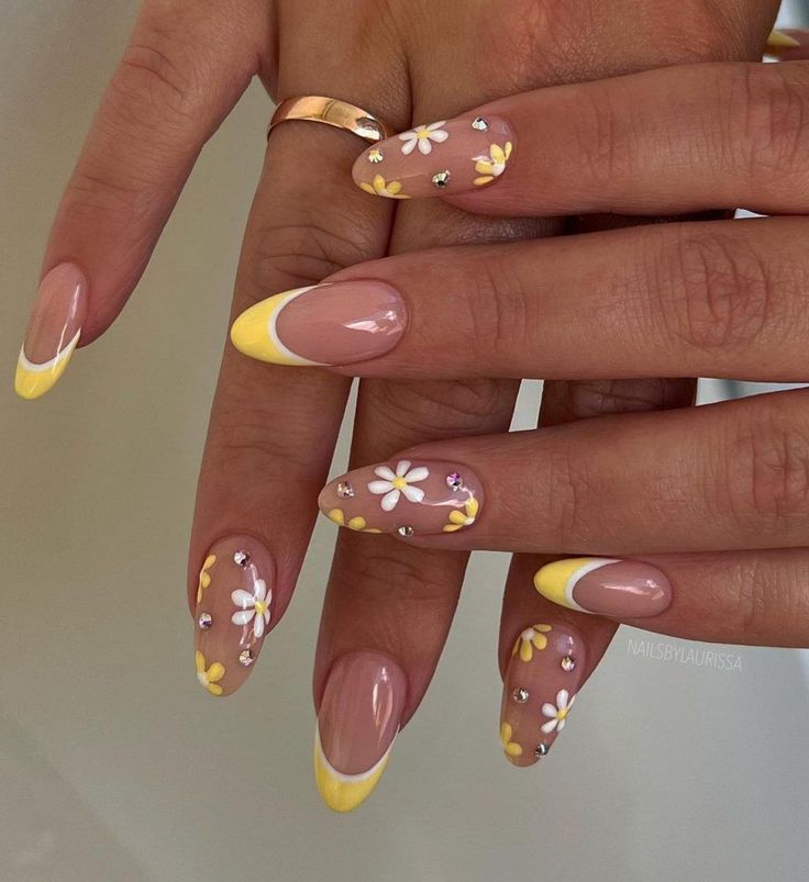 Chic Floral Nail Design: Soft Nude and Vibrant Yellow with Daisies and Rhinestones for Spring/Summer.