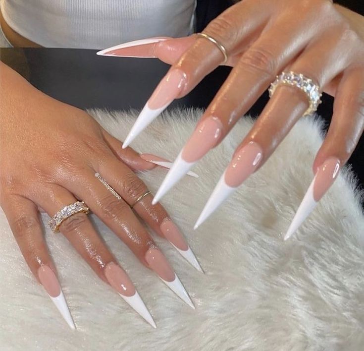 Elegant Stiletto Nails: Natural Pink Gradient with Bold White Tips for a Fashion-Forward Statement.