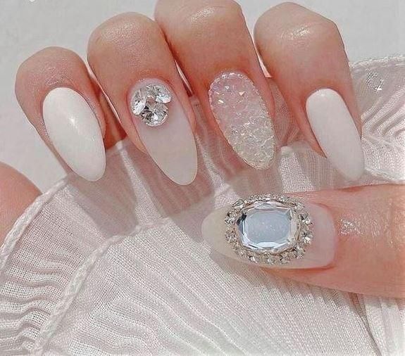 Chic Nail Design with Textures and Sparkling Crystal Accents.