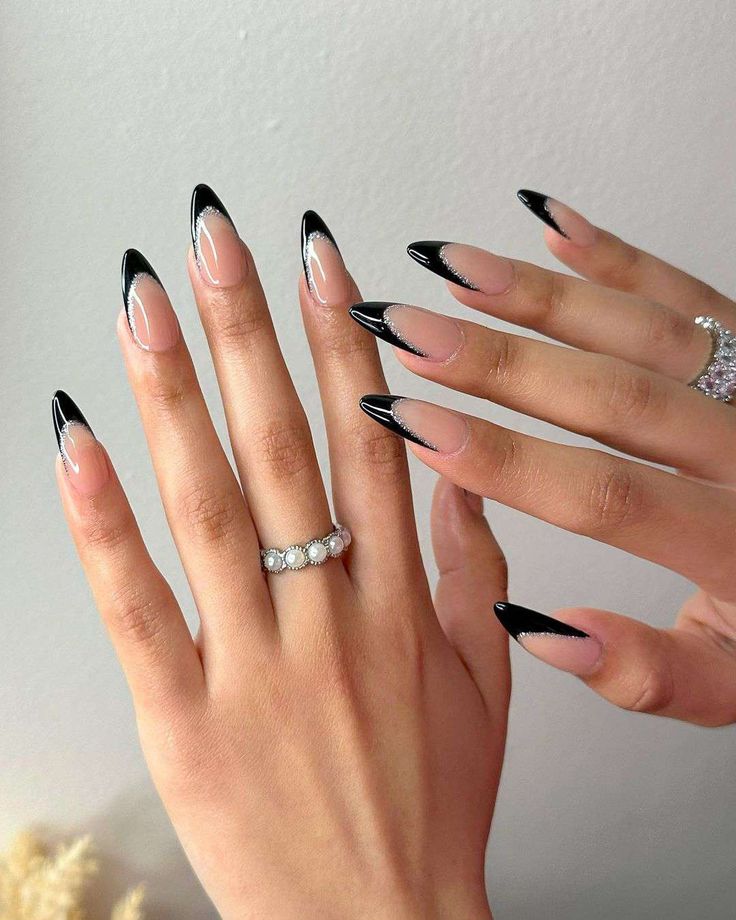 Elegant Elongated Stiletto Nails with Black Tips and Silver Accents