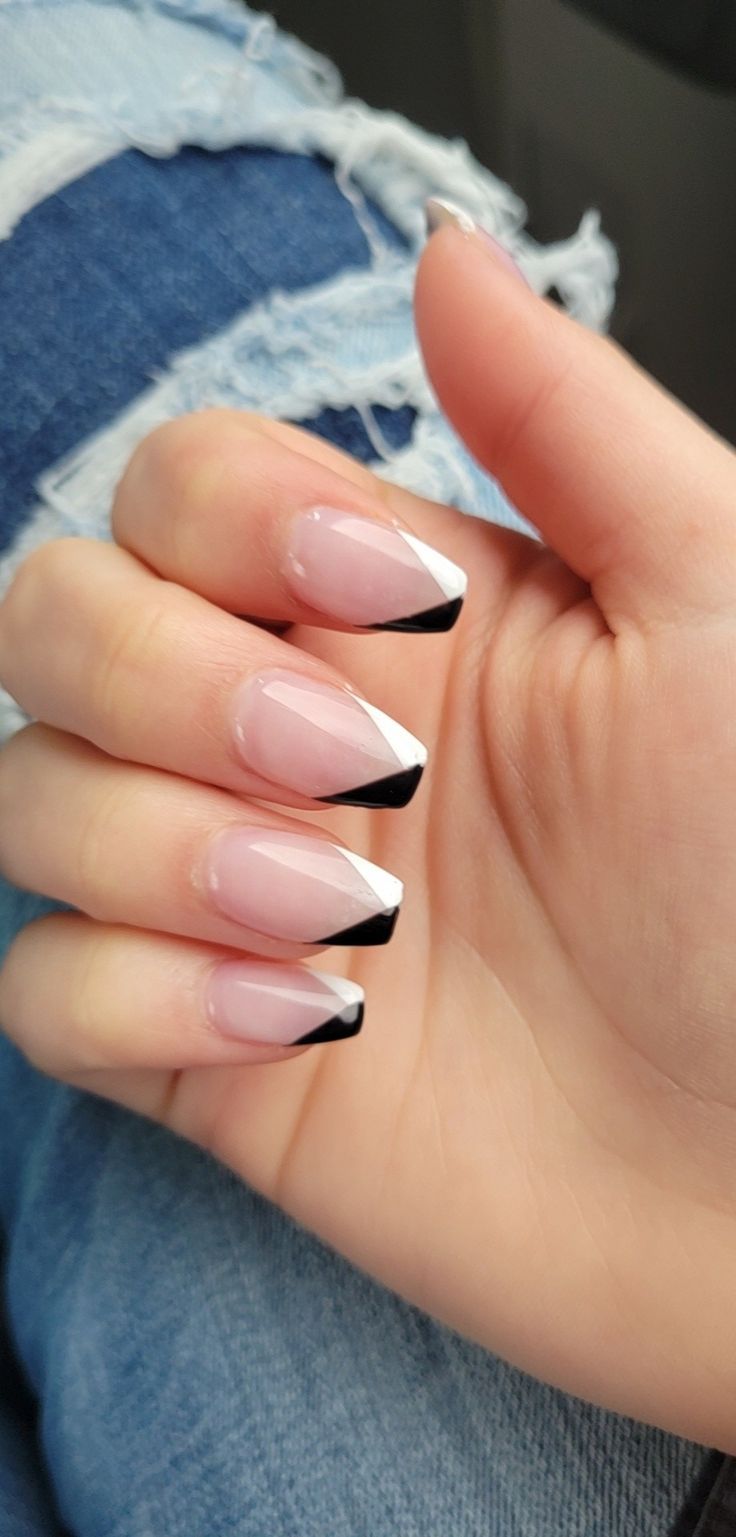 Sophisticated Chic Nail Design: Modern French Tips with Soft Pink Base and Bold Black & White Accents.