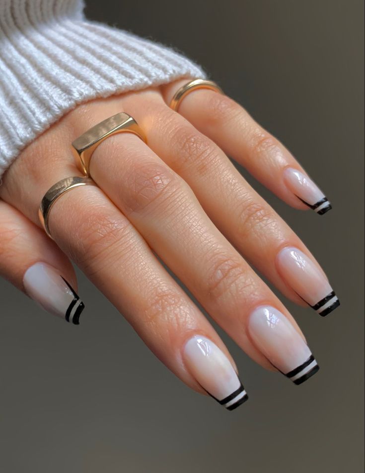 Chic Gradient Nail Design with Black Tips and Elegant Gold Accents.