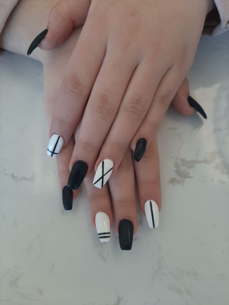 Chic Black and White Geometric Nail Design with Eye-Catching Artistic Detailing.