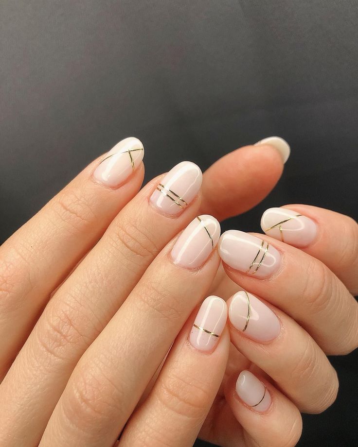 Sophisticated Minimalist Nail Design with Soft Neutral Base and Delicate Gold Accents.