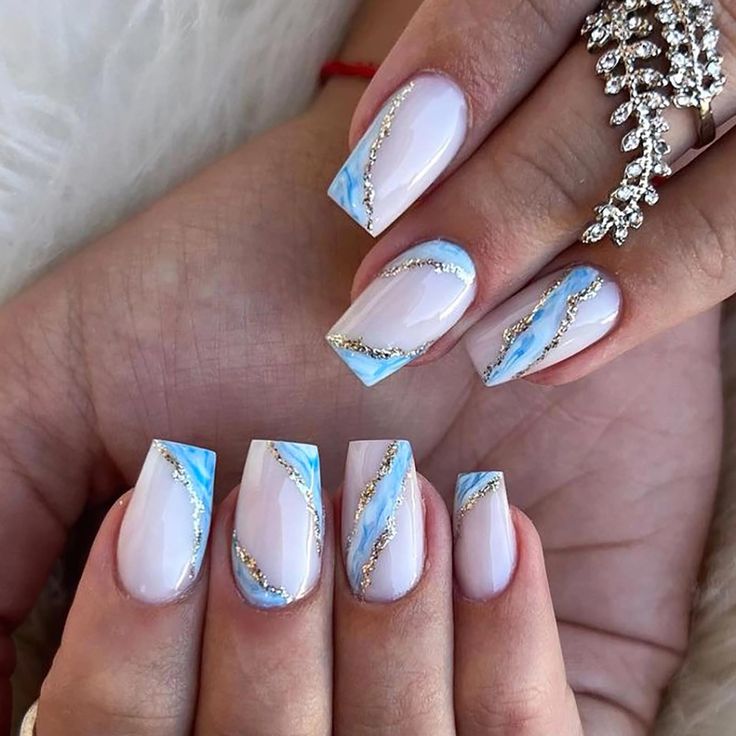 Chic Ocean-Inspired Nail Art: Blue-White Gradient with Glamorous Gold Accents.