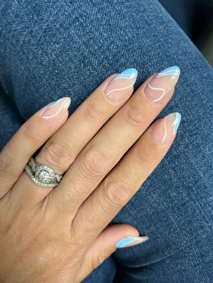 Chic Nail Design: Soft Pink and Vibrant Blue with Playful Wavy Tips.