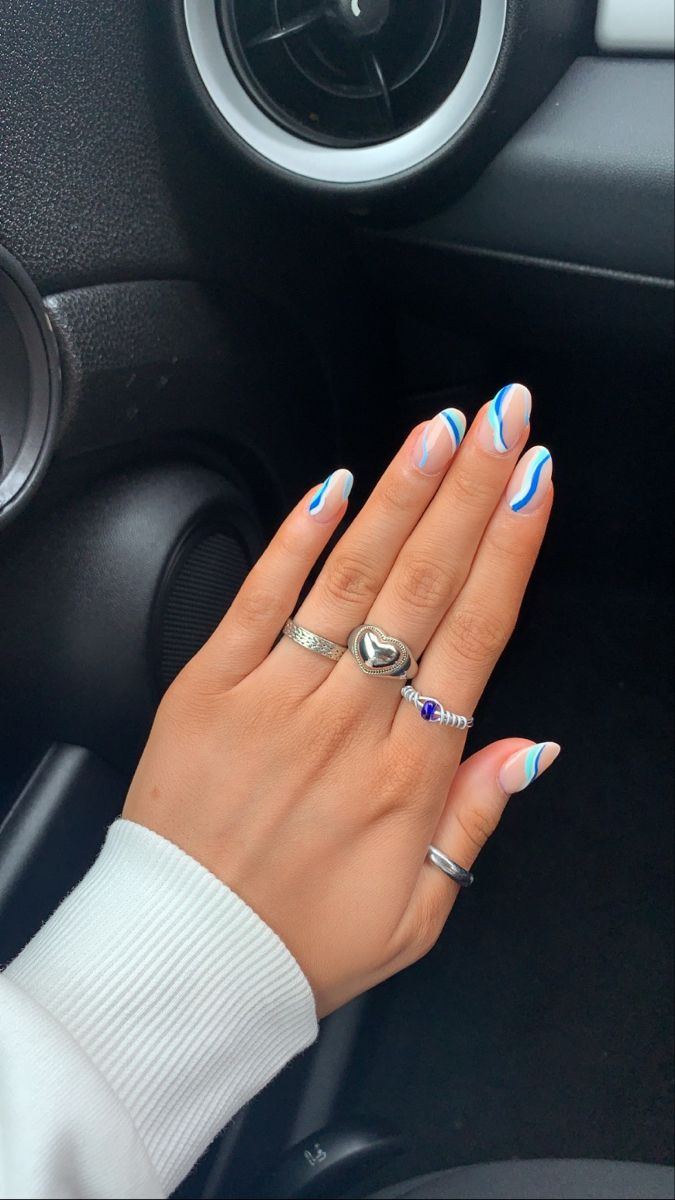 Chic Sophistication: Modern Nail Design with Soft White and Vibrant Blue Lines Accented by Elegant Rings