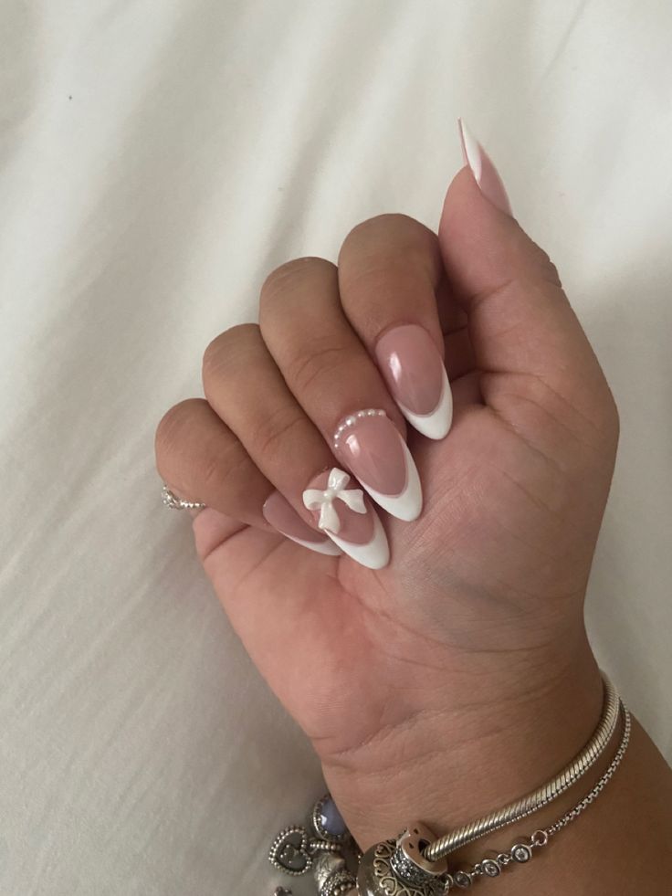 Playful Classic French Manicure with Modern Bow Accents and Soft Pink Undertones.