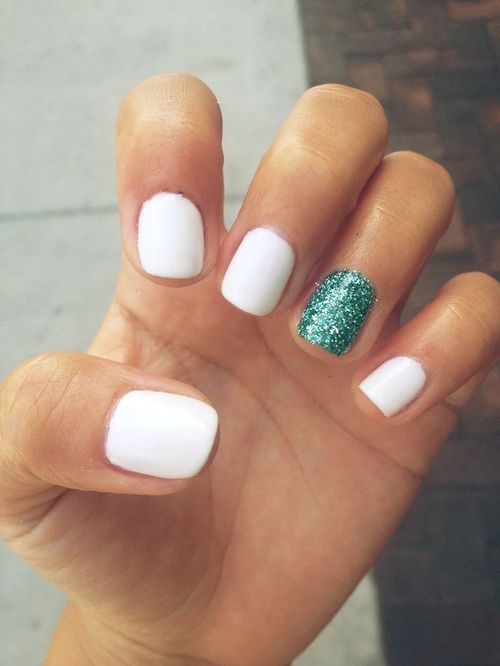 Glamorous Classic White Nail Design with Sparkling Green Accent