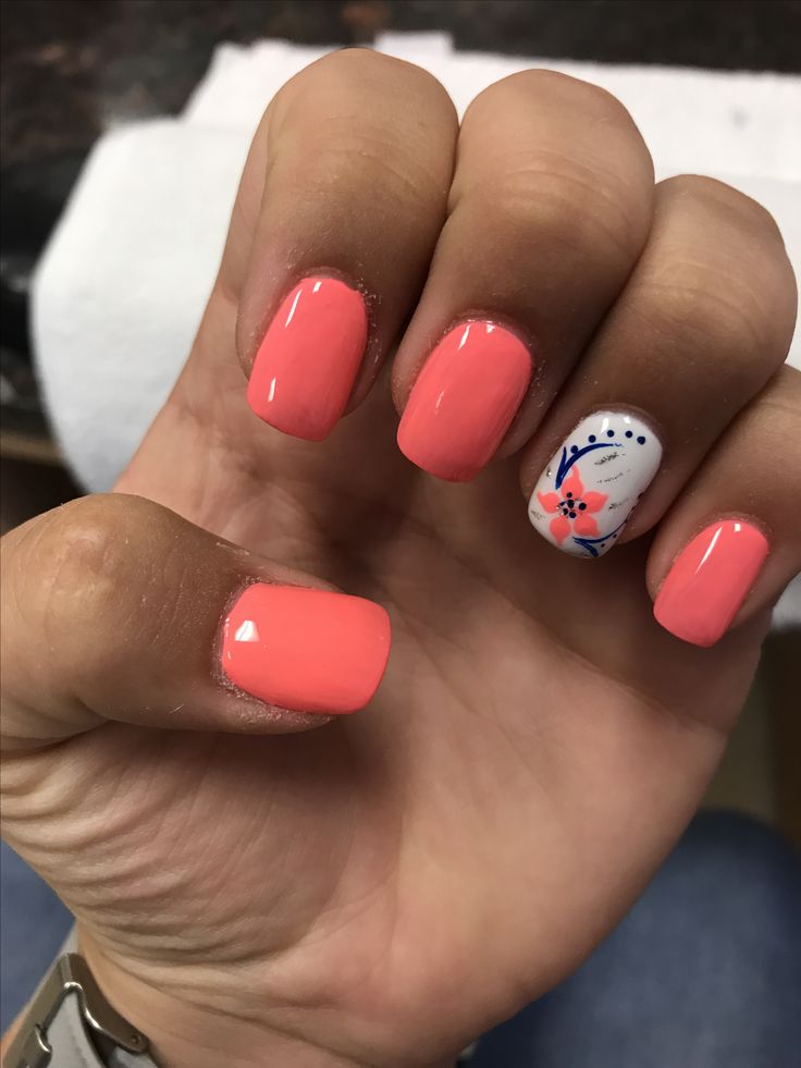 Vibrant Coral Nail Design with Floral Accent for a Playful, Stylish Manicure