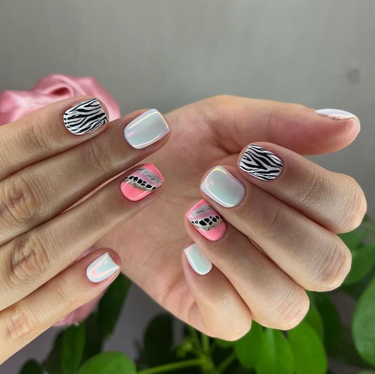 Playful and Modern Nail Design: Pastel Pink and Crisp White Zebra Patterns with Geometric Flair.