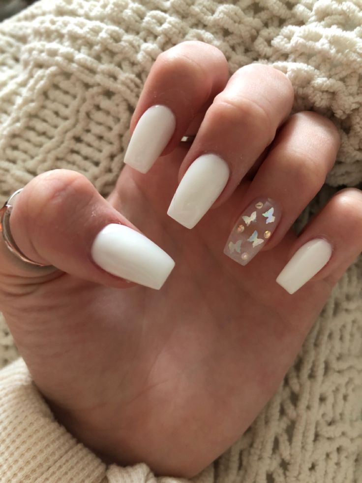 Chic White Nail Design with Glitter Butterfly Accent.