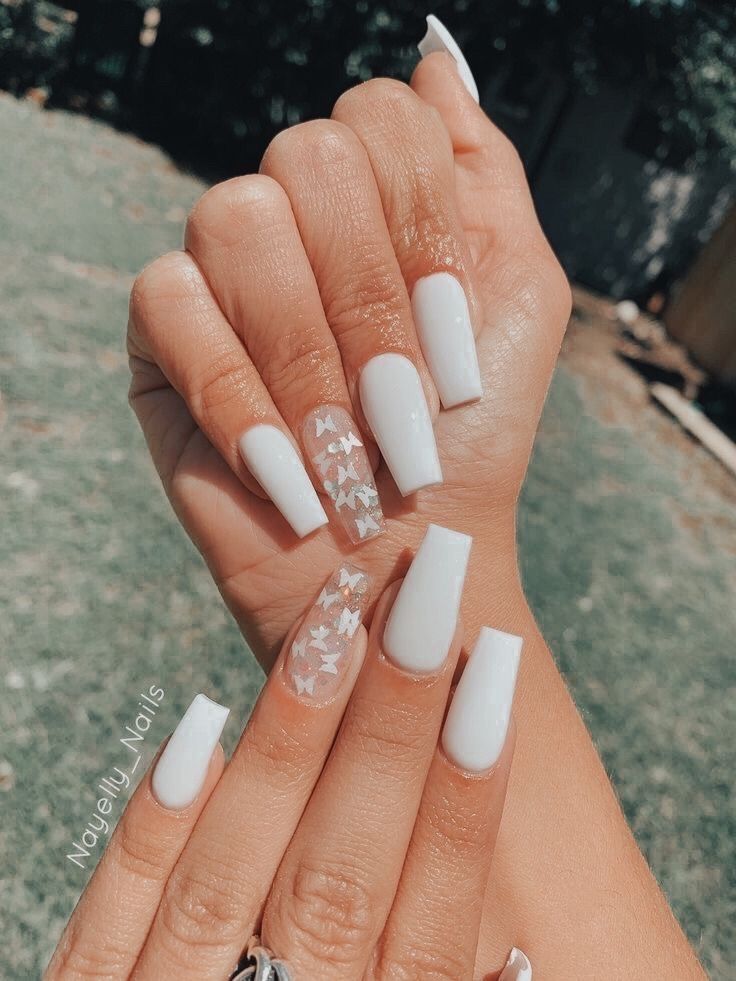 Chic Elegant White Nails: A Blend of Classic and Trendy Designs with Playful Accent Patterns.