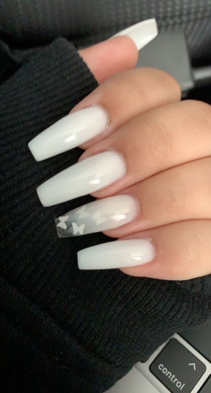 Chic White Gradient Nail Design with Whimsical Star Accent.