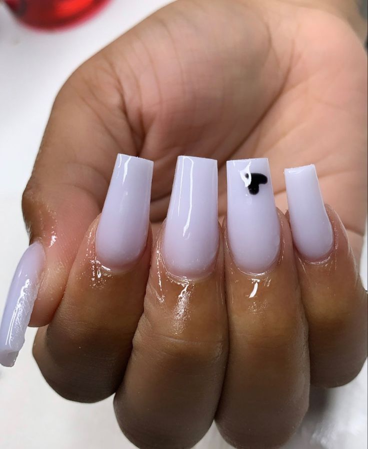 Trendy and Sophisticated Glossy Lavender Square Nails with Playful Black Accent.