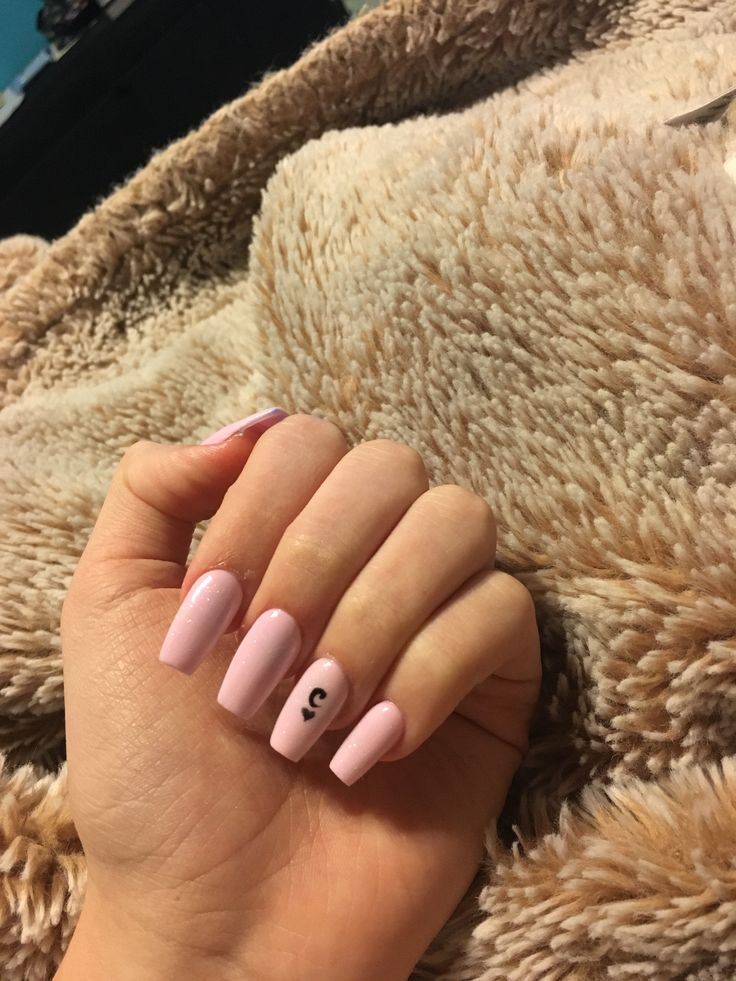 Charming Elegant Soft Pink Nail Design with Playful Accent.