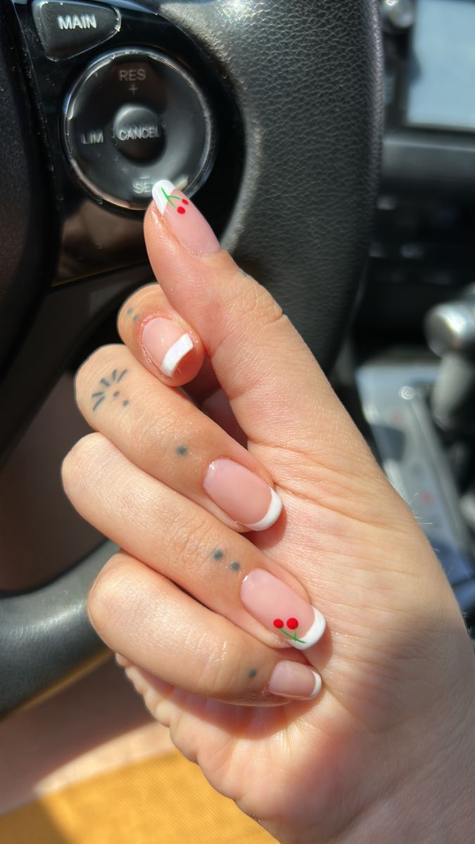 Chic Soft Pink Nail Design with Elegant French Tips, Green Lines, and Playful Red Dots.