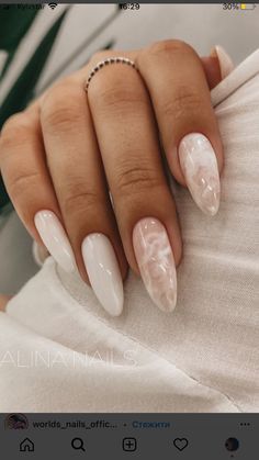 Sophisticated Almond-Shaped Nails with Soft White and Unique Marbled Accents.