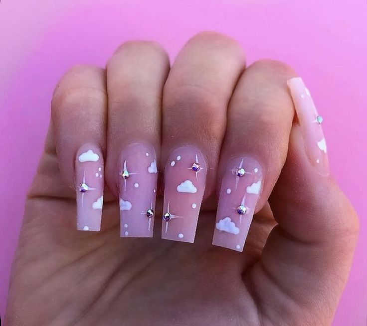 Charming Cloud-Themed Nail Design with Pink Base, White Patterns, and Sparkling Silver Studs