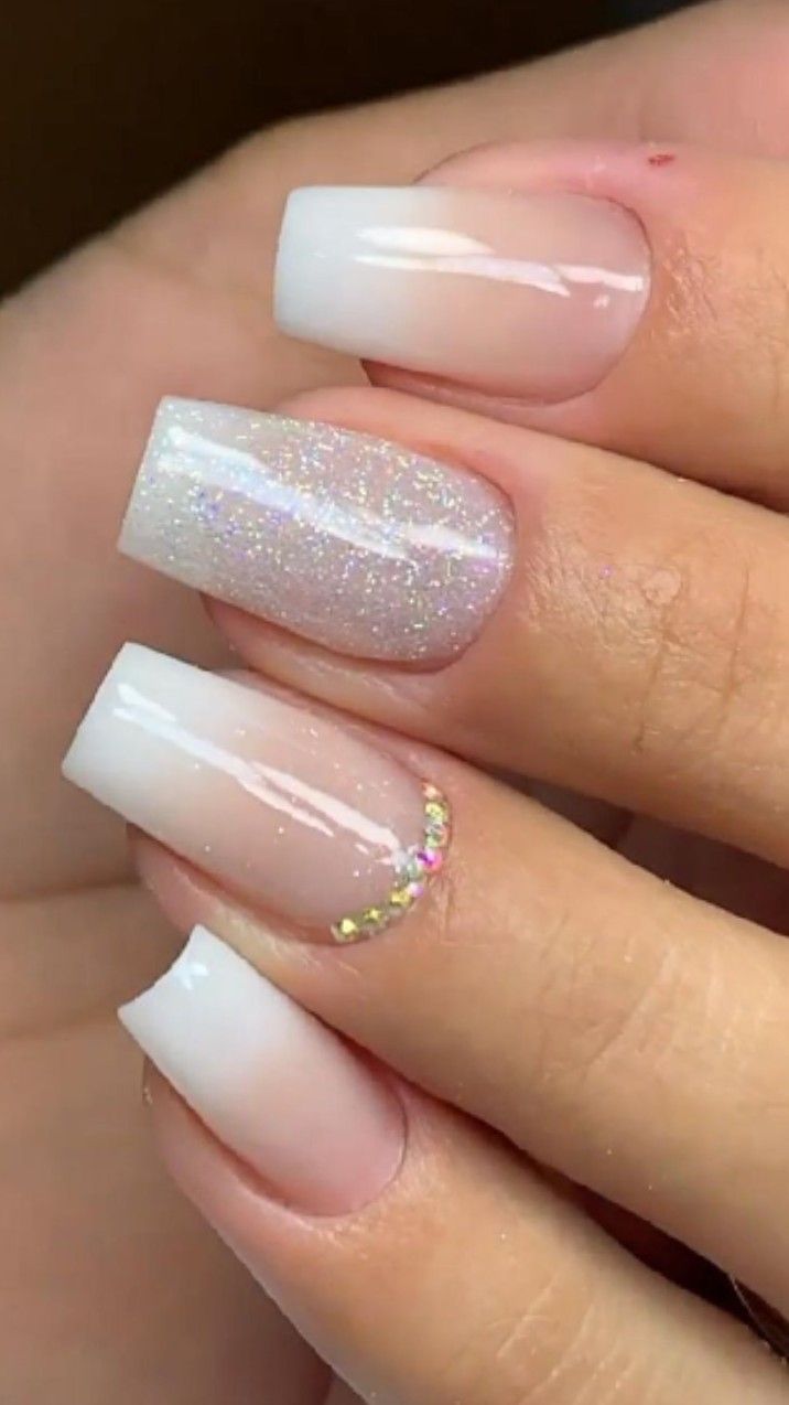 Chic Ombre Nail Design with Glitter and Rhinestone Accents.