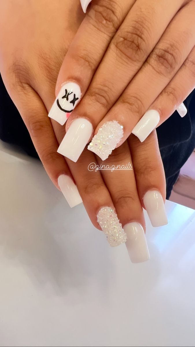 Chic White Nail Design with Playful Smiley Face and Sparkling Rhinestones