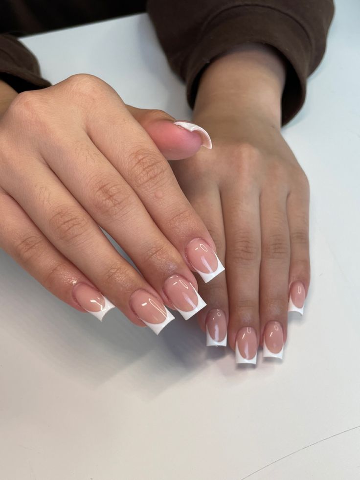 Elegant French Manicure: A Chic Blend of Nude Pink and White Tips for Any Occasion.