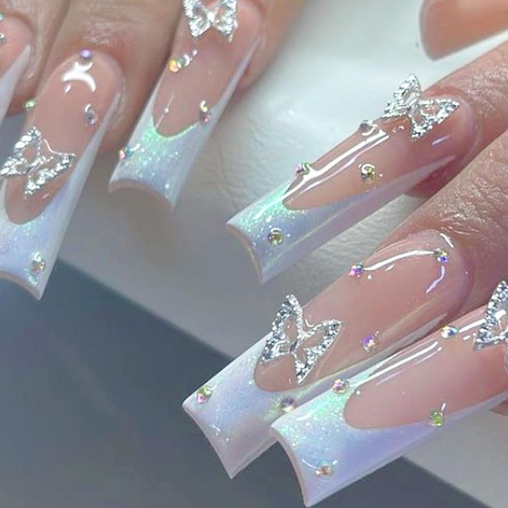 Glamorous Stiletto Nail Design with Holographic Accents, Butterfly Embellishments, and a Captivating Gradient Finish.