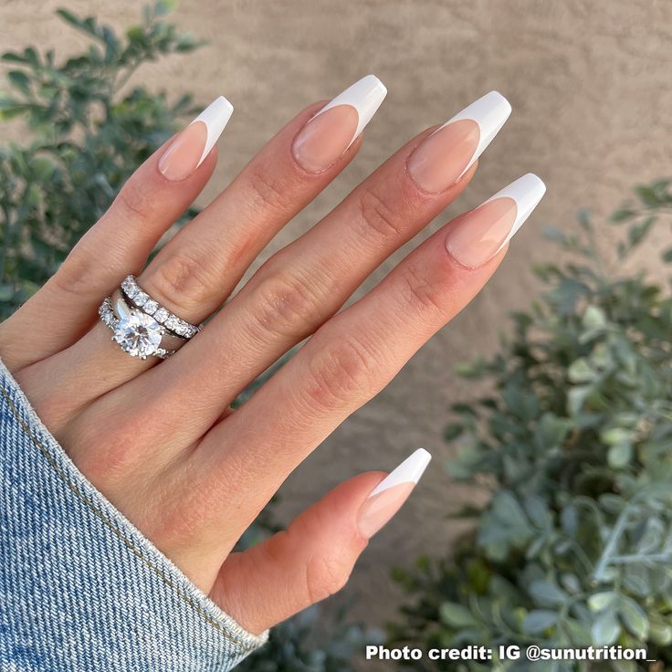 Timeless Elegance: Chic French Tip Nails with Glamorous Rings.