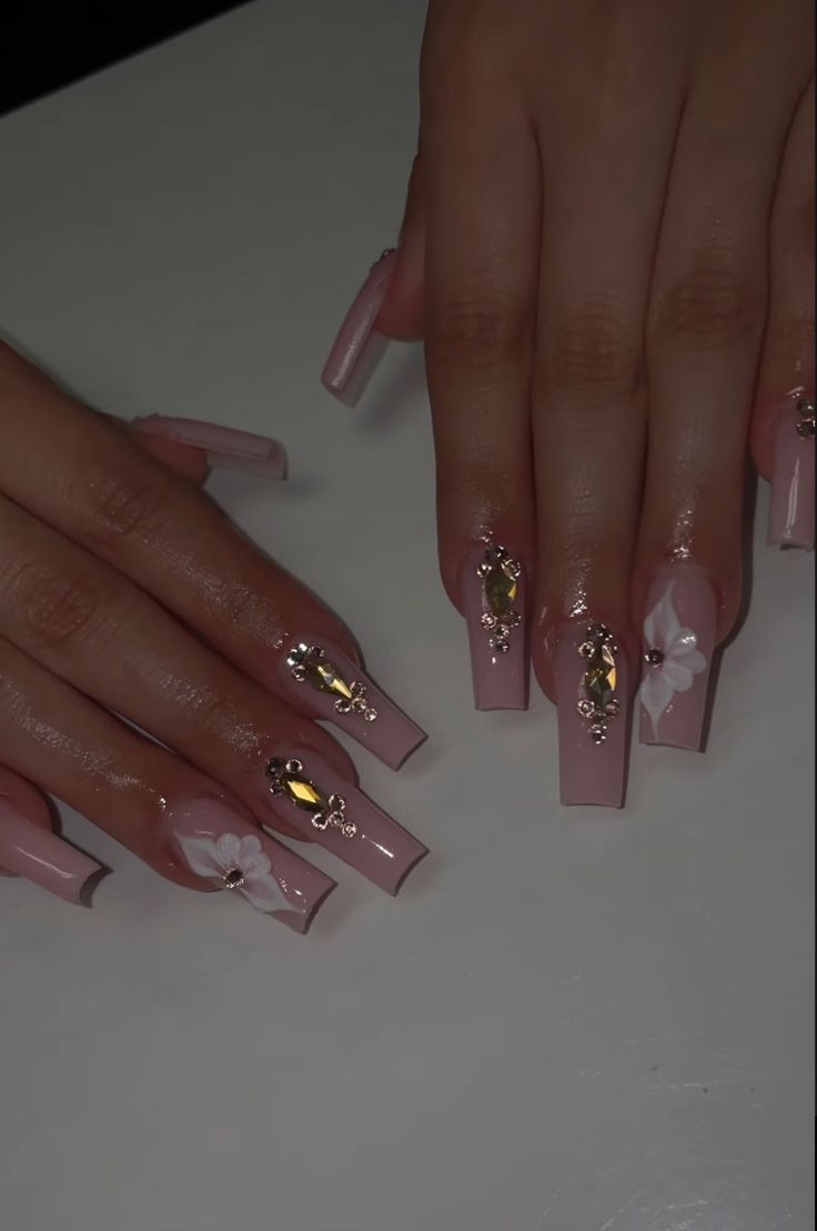 Chic Soft Pink Nail Design with Glossy Finishes and Luxurious Embellishments.