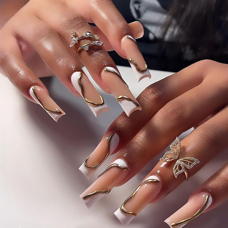 Sophisticated Almond-Shaped Nail Art with Glossy Nude Base and Elegant Gold Swirls.