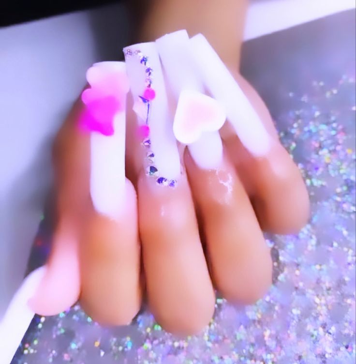 Playful Pastel Nail Design with 3D Heart Embellishments and Sparkling Accents.