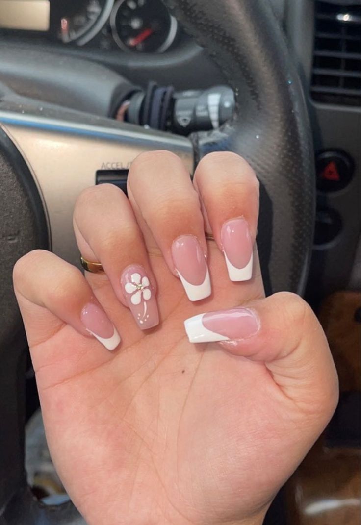 Elegant French Tip Nails with Soft Pink Base and Playful Floral Design.