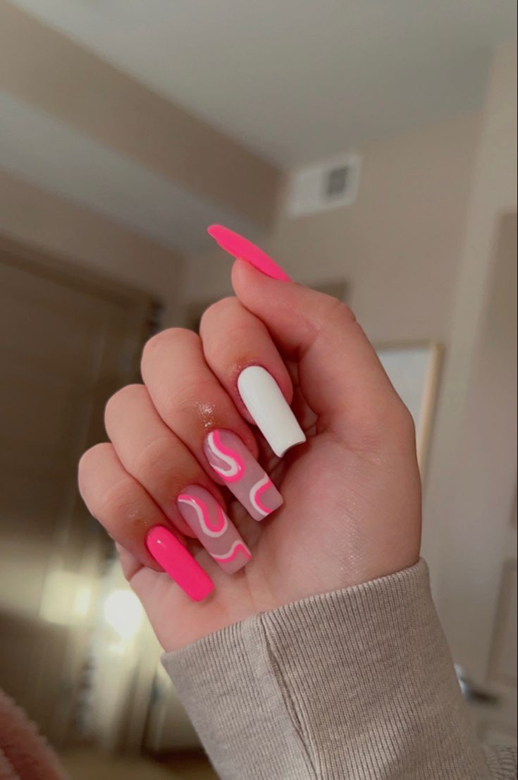 Vibrant Pink and White Nail Design with Artistic Swirls for a Playful Modern Aesthetic