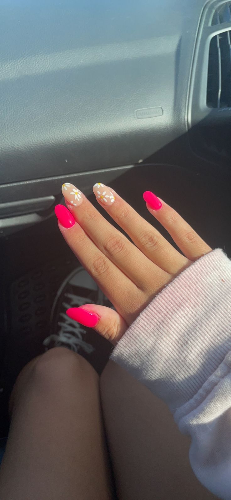 Stylish and Playful Nail Design: Vibrant Pink with Delicate Floral Accents